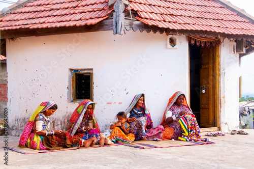 Tribal women in front of their hut, Kutch, Gujarat, India.