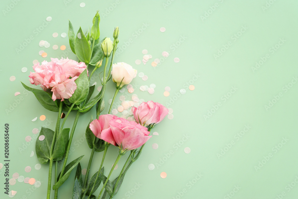 Fototapeta premium Top view image of pink flower over blue background .Flat lay