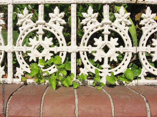 Ornate white painted Victorian wrought iron fencing lacework panel