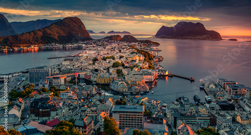 Dramatic summer view from flying drone of Alesund port. Fantastic sunset in west coast of Norway, at the entrance to the Geirangerfjord. Traveling concept background.