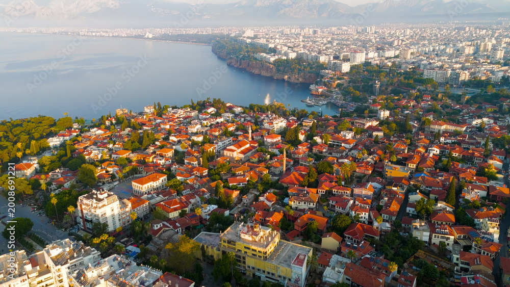 Obraz premium Antalya, Turkey. Aerial drone panorama of Kaleici Old Town, yacht marina, Mediterranean Sea and Taurus Mountains backdrop in morning light.. Aerial View