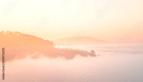 Hills covered in soft fog at sunrise, with warm golden and pink light illuminating the landscape, peaceful and serene atmosphere