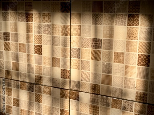 Vintage-style mosaic tiles with beige and brown textures. A detailed geometric pattern for home decor backgrounds.