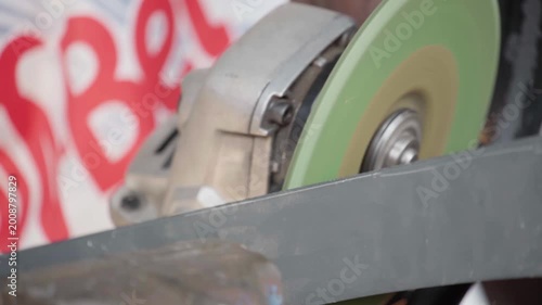 Close up of an angle grinder blade starting to cut metal