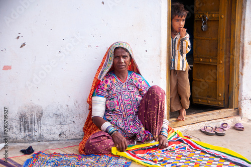 Tribal women in front of their hut, Kutch, Gujarat, India.