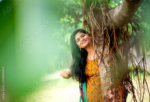 Happy woman near banyan tree