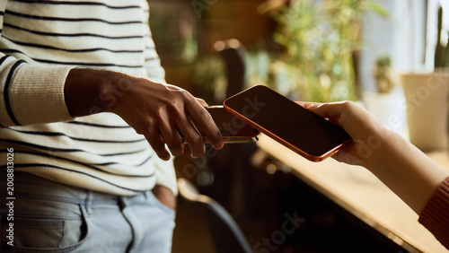 Fotografie Close up of mobile banking payment between two smartphones