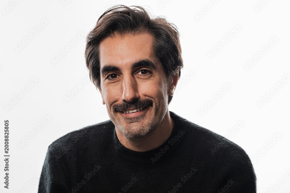 Fototapeta premium Captivating smile of a man in a cozy sweater against a soft backdrop