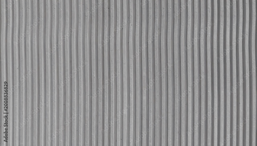 Obraz premium Wide View of Grey wavy Concrete Surface with Vertical Linear Pattern