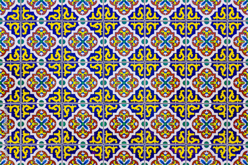 Mexican Ceramic Mosaic Wall. Decorative Mexican ceramic tile pattern with repeating geometric shapes and floral elements. Tile Background. Colorful Mexican geometric tile ornament with floral elements
