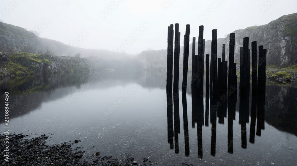 Fototapeta premium Dark wooden pillars standing in a misty lake within a rocky quarry. Mysterious landscape featuring strange totem installation in deep water. Atmospheric scenery for gothic fantasy concept.