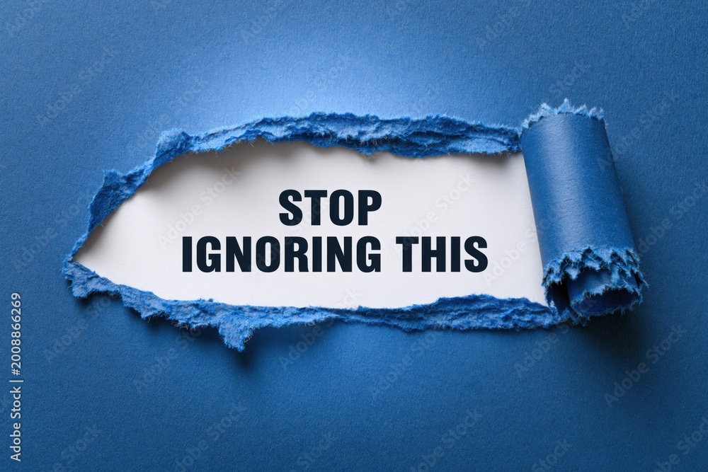 Naklejka premium Stop Ignoring This an urgent message revealed in a torn paper window