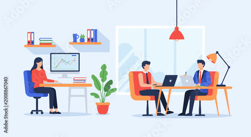 Two people working in an office, one at a computer, the other at a desk