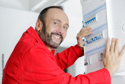 Photography male hand switching on fuse board
