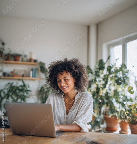 Woman working on laptop at home, remote work lifestyle in cozy interior
