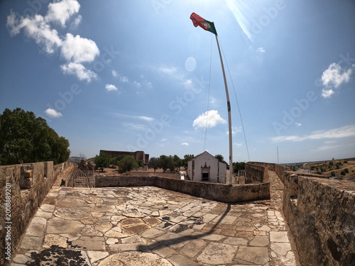 Portuguese Flag Waving from the Historic Castro Marim Fortress in Portugal