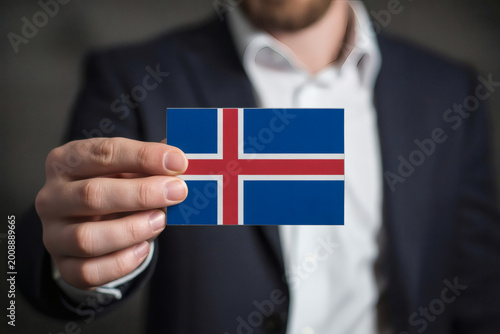 Sharp dressed professional presenting the Iceland flag with pride, perfect for travel blogs or international business ventures