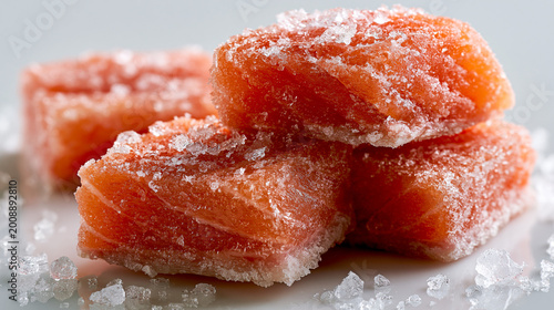 Close-up of salt-cured salmon cubes stacked on white surface with preparation ingredient appetizer