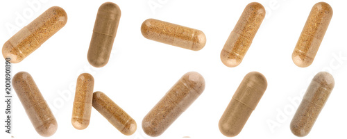 Cuadro en lienzo Group of scattered natural herbal supplement capsules with brown powder, isolated on a transparent background