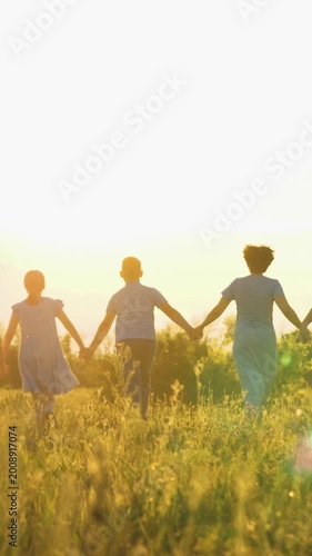 happy family run, parents man woman holding children hands sunset park, mother father parents kid outdoors nature, group celebration at sunset meadow, silhouettes of friends in sunlight, peaceful