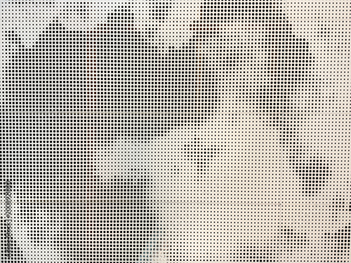 Close up of perforated metals with random tie-dye pattern forming abstract shapes, in white and grey paint color. Perforated metal plate art, for interior design surface. Seamless background texture