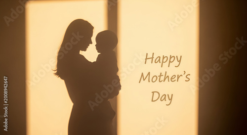 Silhouette of woman holding her baby at sunset. Gentle embrace between mother and child. Concept of unconditional love, family bonding, and motherhood for Mothers Day celebration card.