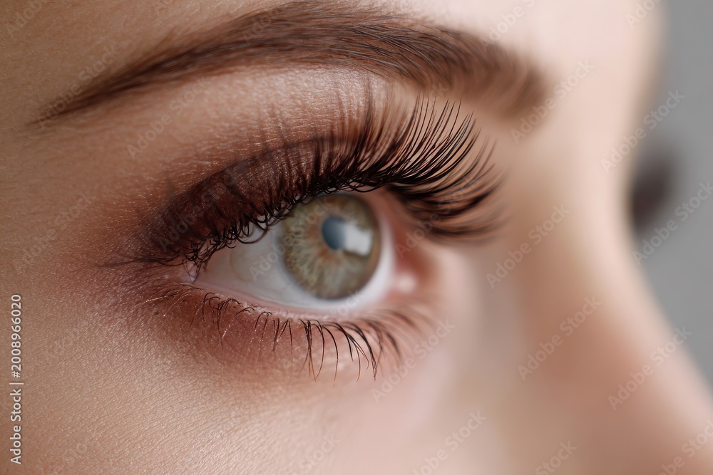 Fototapeta premium Macro Portrait: Woman’s Eye Highlighting Eyelash Extensions