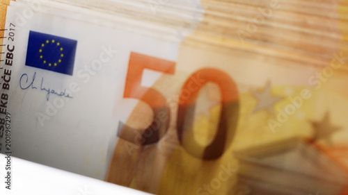 Stack of 50 euro banknotes in an electronic money counter close up. Banking automation for financial literacy and cash assets protection in a business environment.