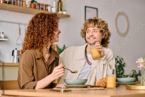 Young couple enjoying breakfast together in their cozy modern apartment