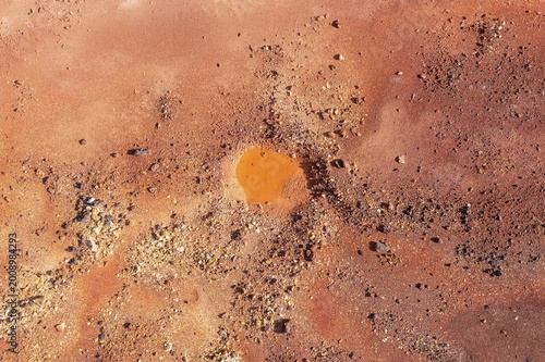 Little pool and extremely mineral-rich ground in the area of the Rio Tinto mines, the colour is caused by oxidised iron minerals, aerial view, drone shot, Huelva province, Andalusia, Spain