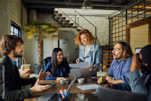 Creative team brainstorming in modern loft office