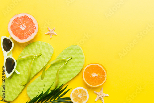 Top view composition of flip flops placed with beach accessories top view on table background. Tropical summer vacation concept Flat lay