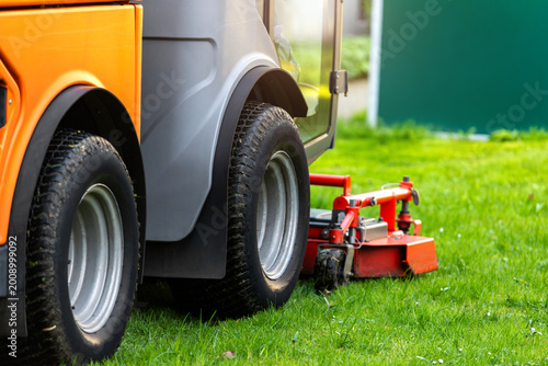 Quadro em tela Modern ev lawn mower machine rotary cutting attachment  fresh green grass maintenance service
