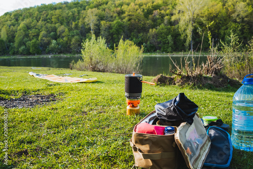 Lakeside Camping Setup Prepared. Prepared Camping Equipment By Lakeside. Setting Up Camping Necessities Beside Peaceful Lake. Organized Outdoor Gear And Supplies For Day Trip At Lake