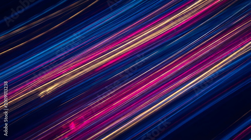 Vibrant colorful streaks move swiftly across a dark background at night