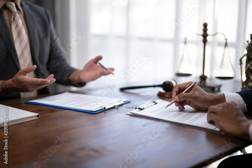 Fotografie Lawyers discussing and reviewing business contract legal documents at office des