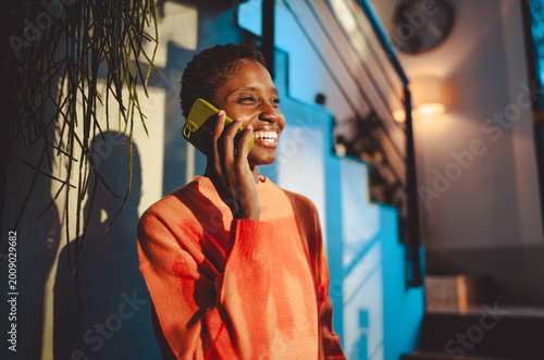 Canvastavla Cheerful woman using a mobile app on her smartphone for online banking or digital communication