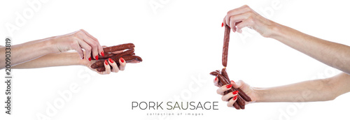 Schilderij op canvas Pork sausage in hands isolated on white background.