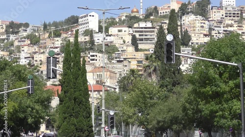 Establishing shot of Nazareth, Israel, showing hillside buildings, mosques, churches, and the city’s mixed architectural landscape. A panoramic view capturing the cultural and historical character