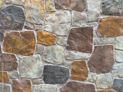 Natural random cut colorful flagstone flattened on a surface, in brown, beige, and grey color. Or a series of cobble stones but flattened and paved seamlessly, for floor or wall finishes.      