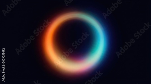 Abstract glowing circular light ring with a soft gradient of orange, yellow, and blue colors on a dark black background