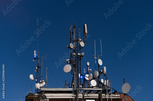 Dense Telecommunications Structure with Multiple Antennas, Masts, and Satellite Dishes