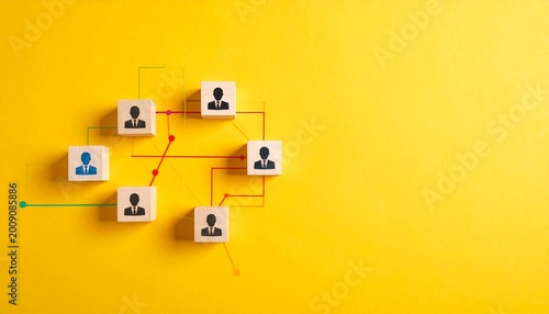 Teamwork network concept, wooden blocks with icons connected by colored lines on yellow background