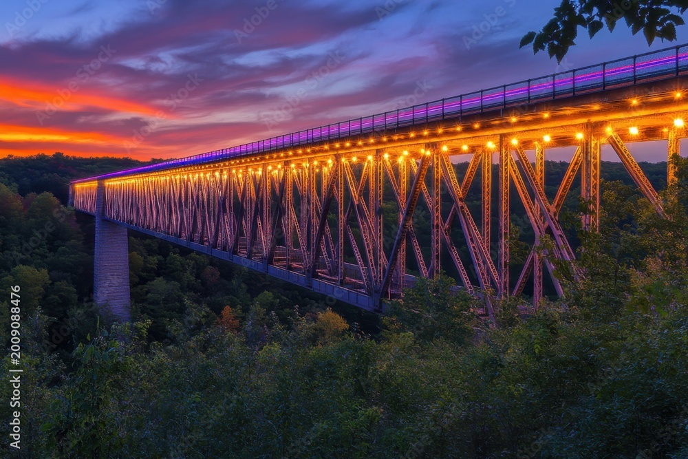 Fototapeta premium Colorful hues illuminate the sunset bridge, crafting a magical view