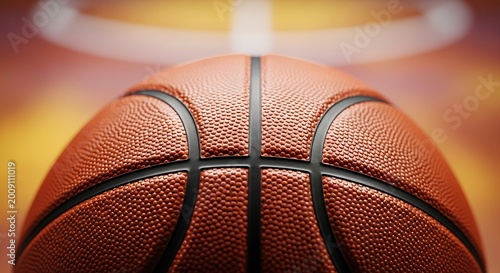 Close-up of a basketball on a court with hoop