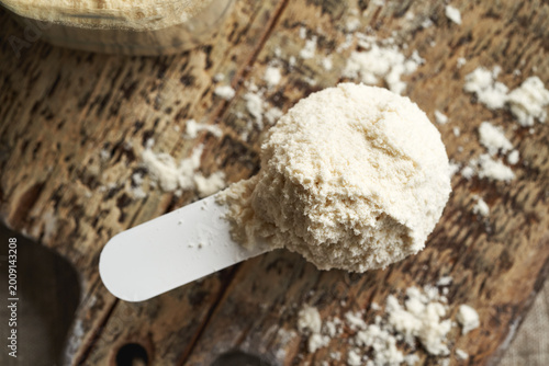 Whey protein powder in a white measuring cup