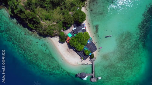 Tropical komodo island beach with people swimming. Lovely aerial view drone