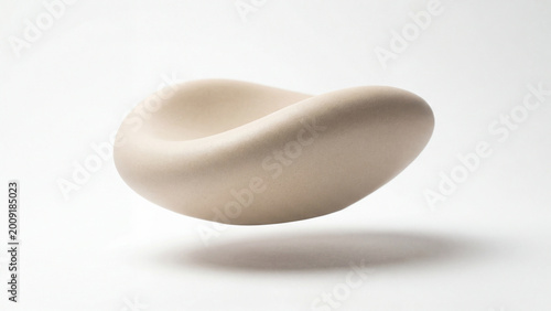 Abstract cream colored sculptural form floating against white background