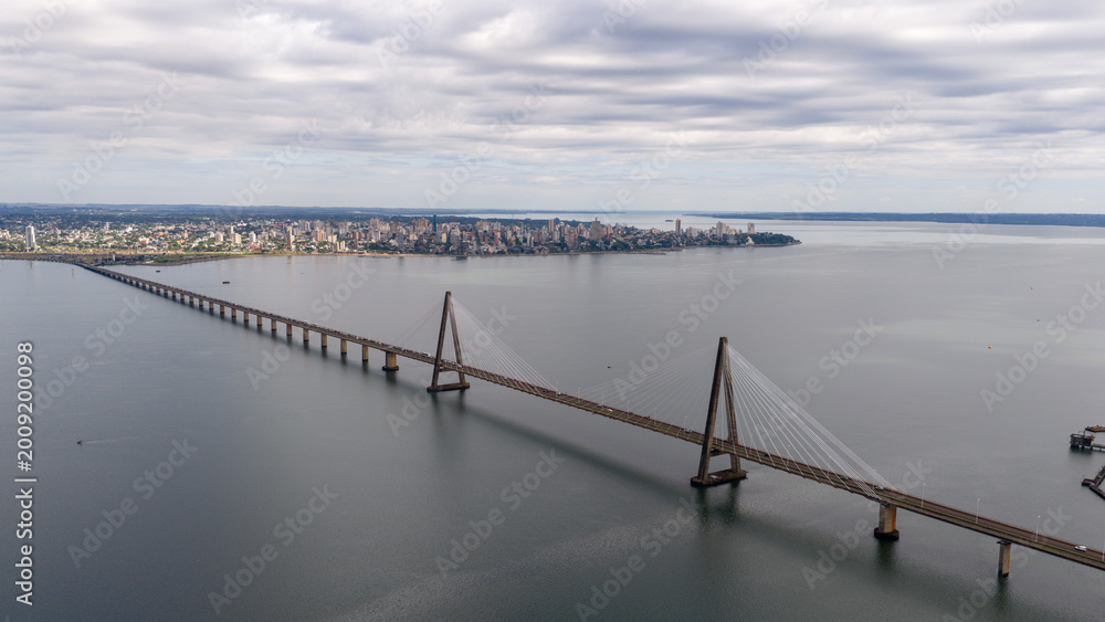Fototapeta premium Side view of the Roque Gonzalez Bridge stretching across the Parana River on a cloudy day, Argentina and Paraguay.
