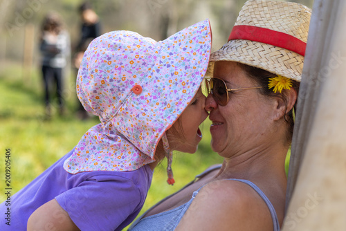 Valokuva Happy family moment showing a mother and her child sharing closeness and joy during summertime